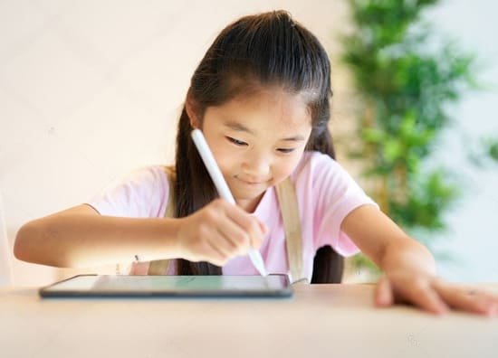 Young student drawing on a tablet with a stylus. Student learning English online.