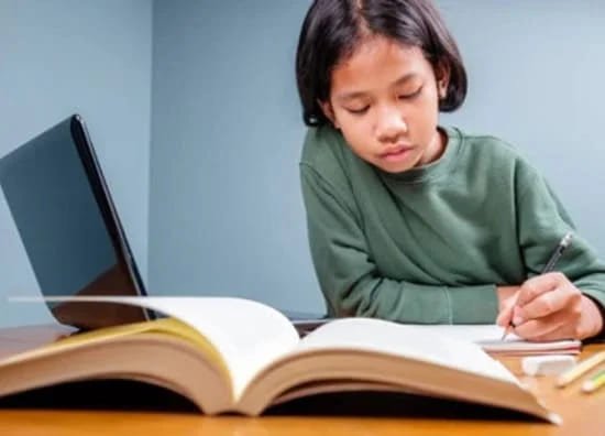 Elementary girl studying online English lessons